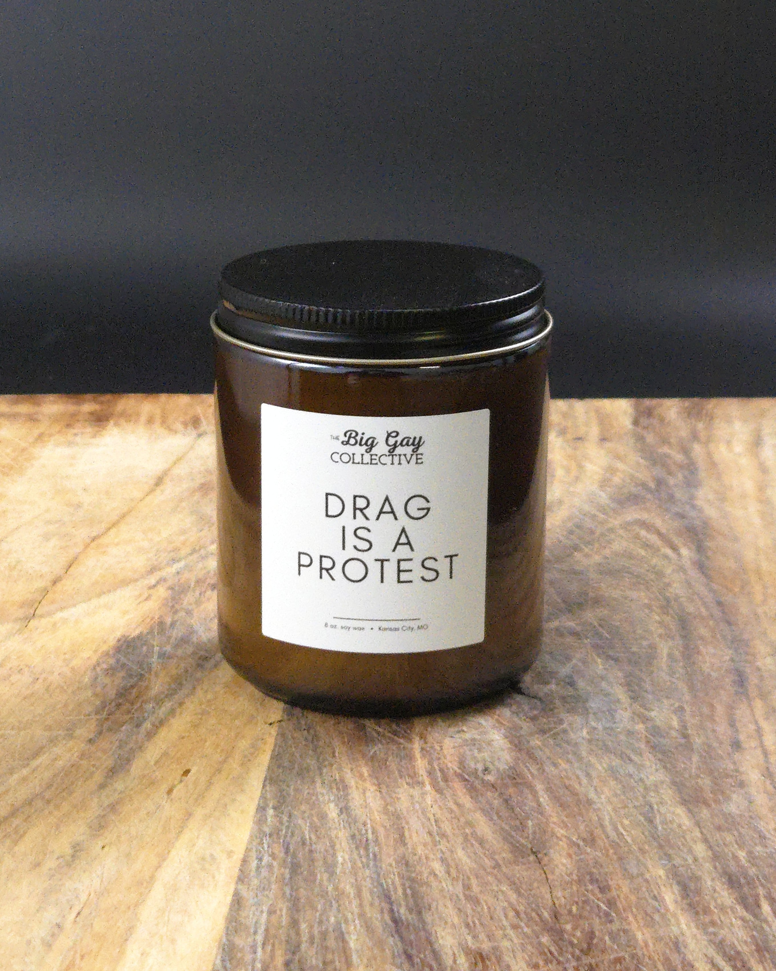 Candle jar with a label on a wooden surface